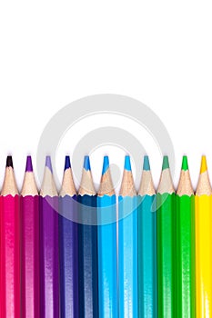 Multicolored wooden pencils in rainbow shades in order on a white isolated background mock up, vertical, high quality