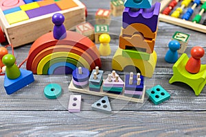Multicolored Wooden rainbow toy, abacus, pencils, blocks on wooden table. Back to school, games for kindergarten, preschool