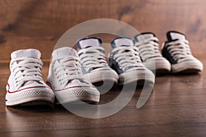 Multicolored youth gym shoes on floor