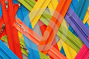 Multicolored Zippers or Zip Fasteners used for binding fabric or textile. Colorful Clasp Lockers Background or Pattern concept of