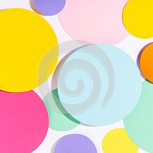 Multicoloured bright lit mosaic of paper circles.