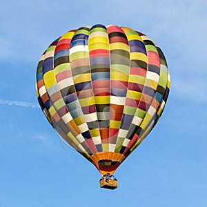 Multicoloured hot air balloon in a clear blue sky