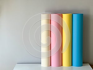 Multicoloured paper in rolls on a simple background
