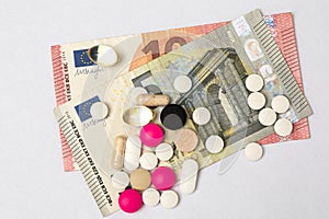 Multicoloured pills and hard capsules and euro banknotes