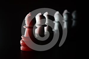 Multicoloured plastic chess pieces on black surface