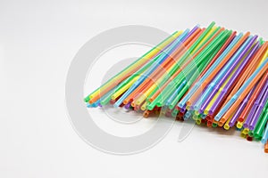 Multicoloured plastic straws on a white background with copy space. Celebration and party background