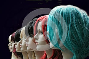 Multicoloured wigs on display