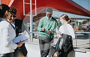 Multicultural business team discussing growth strategies outdoors