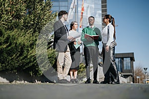 Multicultural business team discussing strategy outdoors