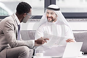 Multicultural businessmen talking and smiling