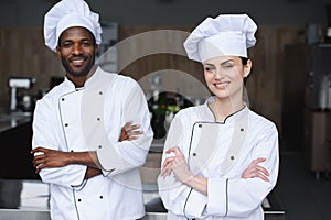 multicultural chefs standing with crossed arms and looking at camera photo