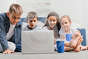 multicultural children resting and watching movie photo