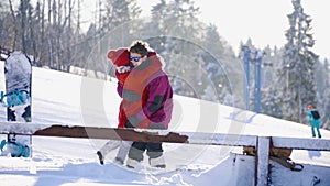 Multicultural coulple dating in mountain ski resort at sunny day. Winter, sport, holidays, relationship, love, xmas