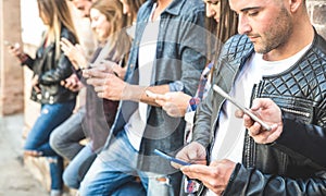 Multicultural friends group using smartphone at university college