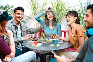 Multicultural group drinking latte at coffee bar restaurant - Happy friend talking and having fun together at hostel dehors