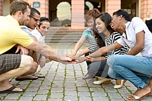 Multicultural group of people squatting together photo