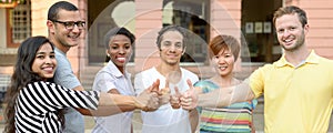 Multicultural group of students giving thumbs up photo