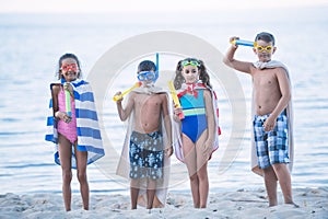 multicultural kids in swimming masks with water toys in hands photo