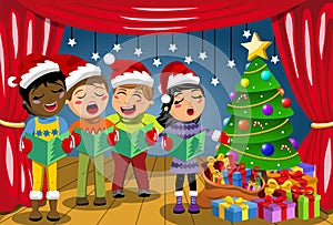 Multicultural kids wearing xmas hat singing Christmas carol nativity play stage