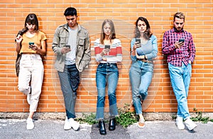 Multicultural people group using smartphone at university college backyard - Milenial friends addicted by mobile smart phone -