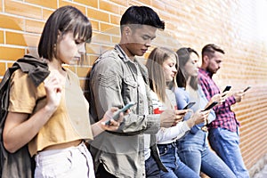 Multicultural people group using smartphone at university college backyard - Milenial friends addicted by mobile smart phone -