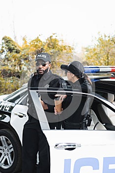 Multicultural police officers with paper cups