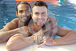 Multicultural same sex couple in the swimming pool