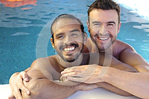 Multicultural same sex couple in the swimming pool