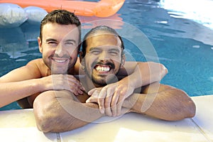 Multicultural same sex couple in the swimming pool