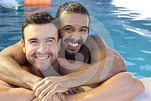 Multicultural same sex couple in the swimming pool