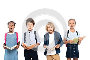 Multicultural and shocked schoolkids holding books