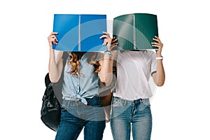 multicultural students covering faces with copybooks