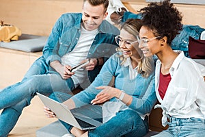 Multicultural students using laptop in lecture hall