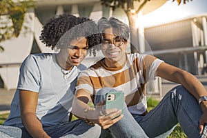 Multicultural teenagers friends laughing selfie cellphone diversity in the modern city street.