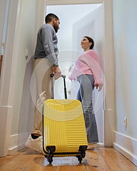 Multicultural Tourists Couple With Yellow Travel Suitcase Entering Their Suite
