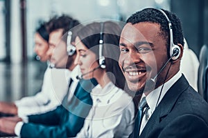 Multicultural young happy employees in call center