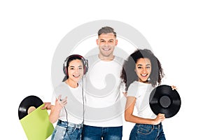 multicultural young people hugging and holding vinyl records isolated