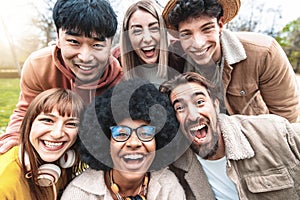 Multicultural young people smiling at camera - Happy group of multiracial students having fun in college campus