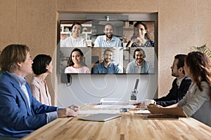 Multiethnic applicants on TV screen during group job interview event