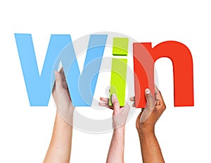 Multiethnic Arms Raised Holding Text Win photo