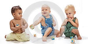 Multiethnic babies playing with blocks