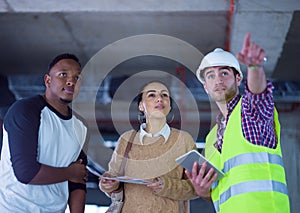 Multiethnic business people,architect and engineer on construction site