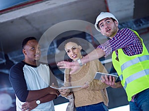 Multiethnic business people,architect and engineer on construction site