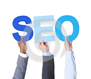 Multiethnic Business People Holding the Word SEO