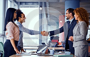 Multiethnic business teams at meeting room shaking hands.