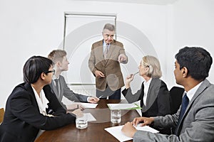 Multiethnic businesspeople at meeting in conference room