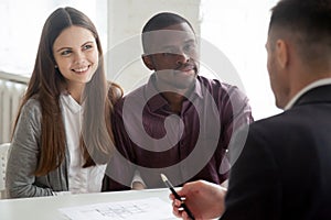 Multiethnic couple consulting real estate agent on buying house