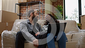 Multiethnic couple finding home decor inspiration on laptop