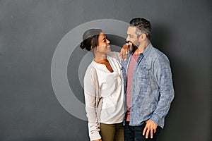 Multiethnic couple looking at each other with a smile