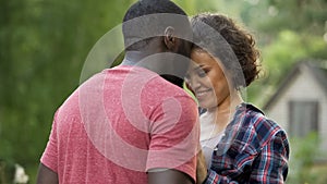 Multiethnic couple tenderly hugging happy to see each other, longawaited meeting photo